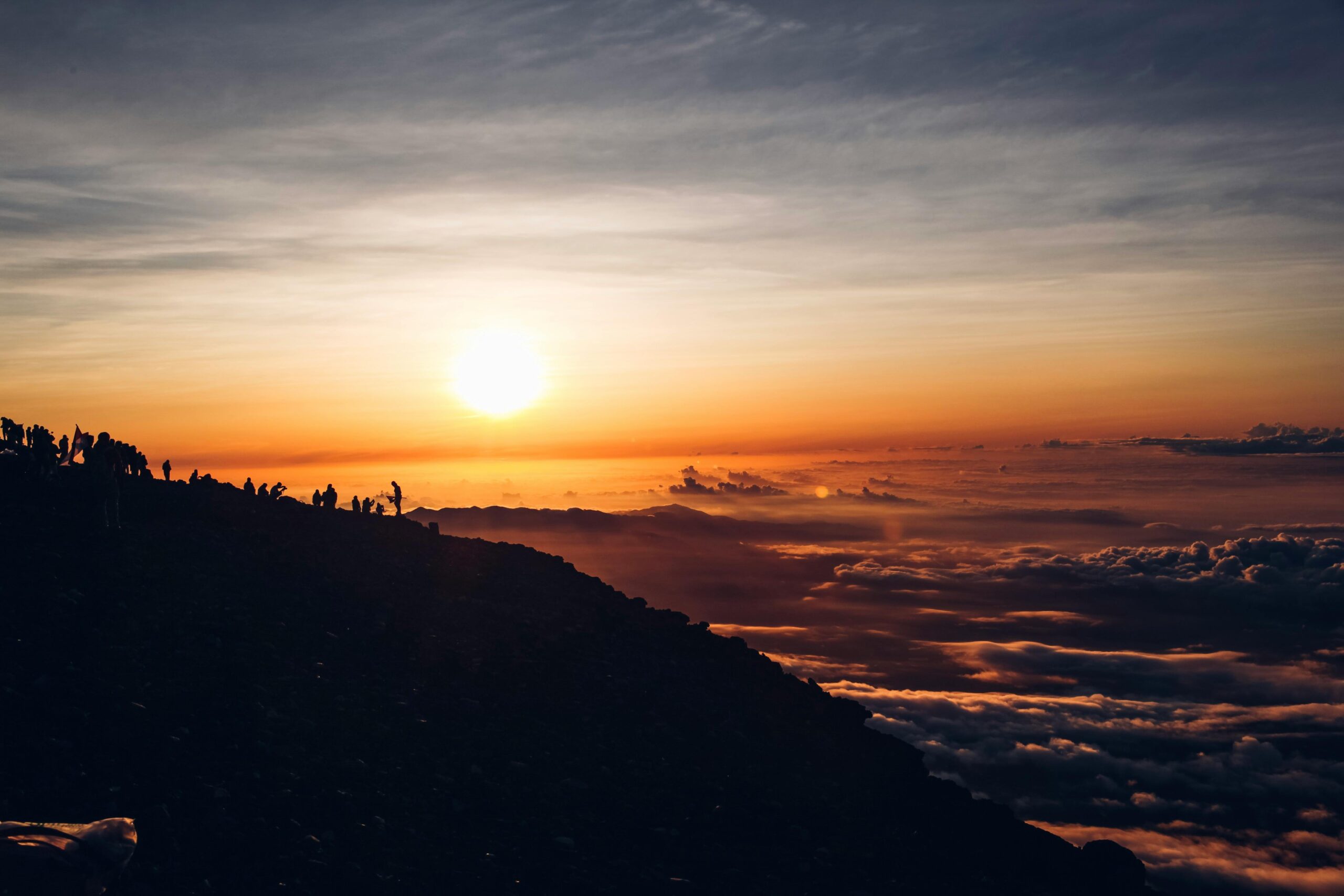 Beautiful sunrise over a mountain peak in Japan, revealing a breathtaking sea of clouds and silhouettes.