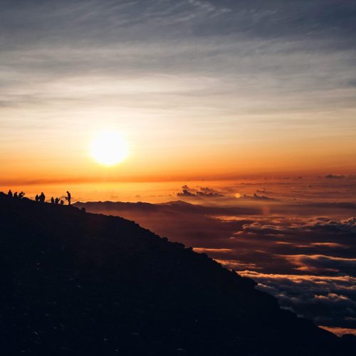 Beautiful sunrise over a mountain peak in Japan, revealing a breathtaking sea of clouds and silhouettes.